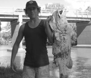 Local Karl Ware holding onto a 20kg cod that was killed by the recent downpour. 